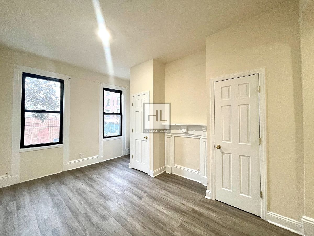 51-28 35th Street, Unit 2 Queens, NY 11101 - Photo 1 of 7 a view of a kitchen with wooden floor and windows