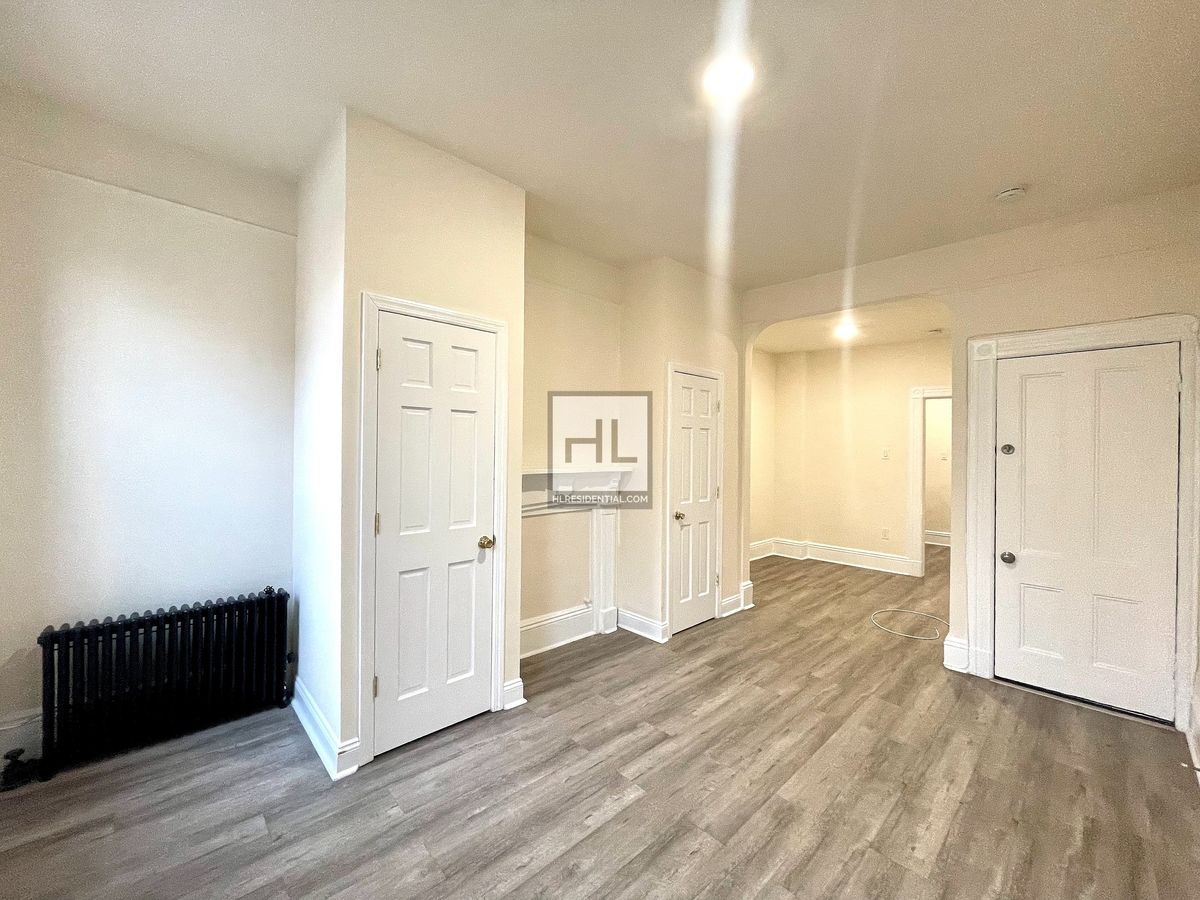 51-28 35th Street, Unit 2 Queens, NY 11101 - Photo 2 of 7 wooden floor with white walls