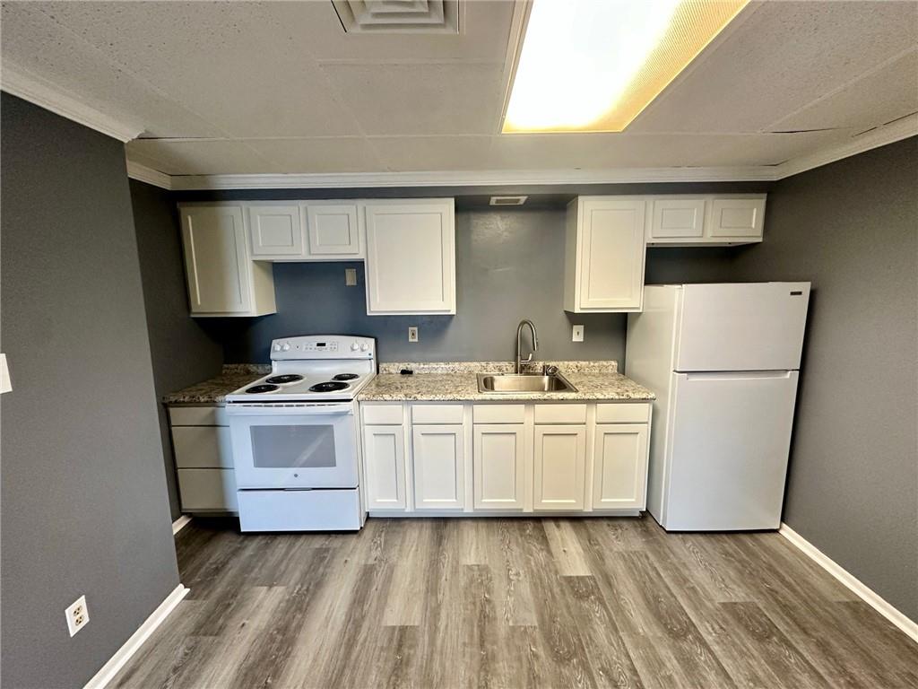 305 Bessemer Avenue, Unit 3B East Pittsburgh, PA 15112 - Photo 3 of 8 a kitchen with a stove a sink and a refrigerator