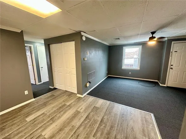 a view of a livingroom with an empty space and a window