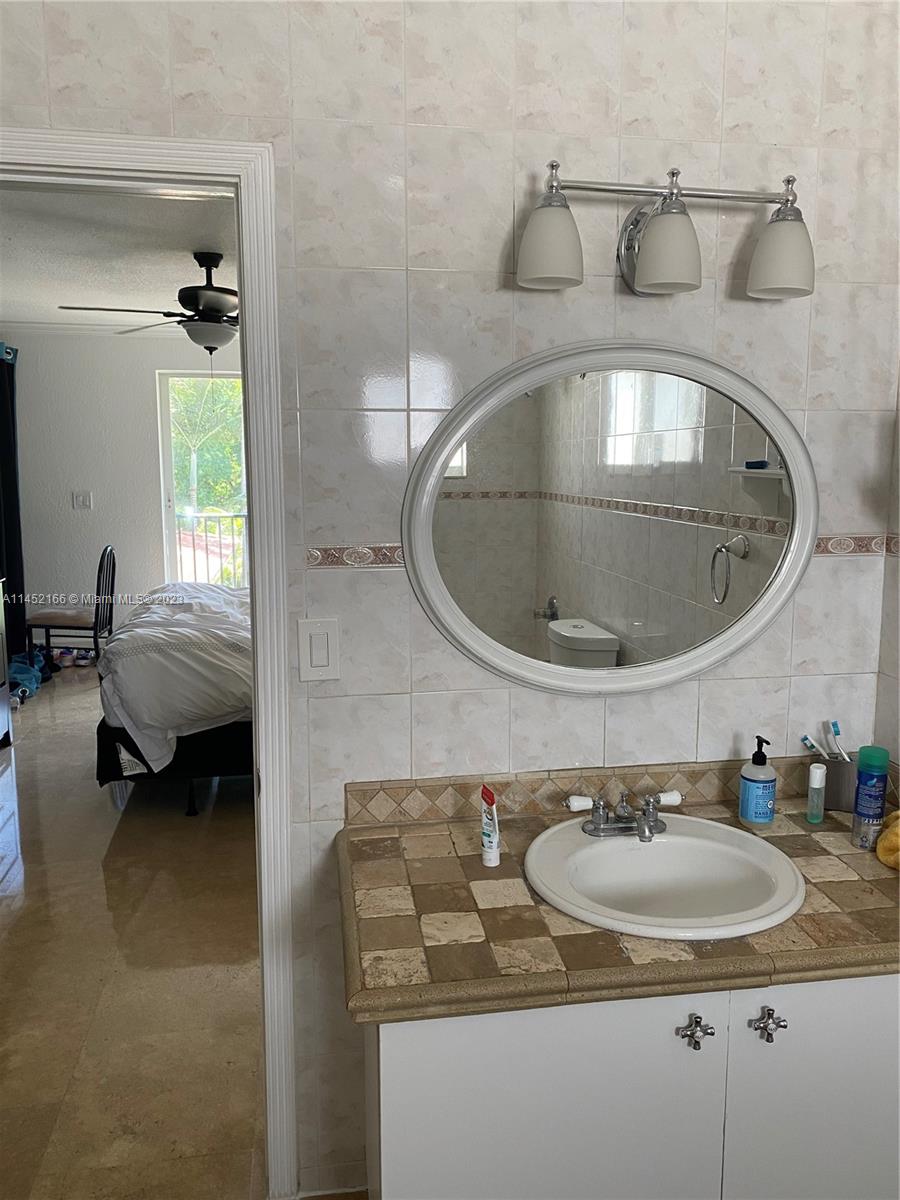 240 Southwest 15th Road, Unit 110 Miami, FL 33129 - Photo 11 of 17 a bathroom with a sink and a mirror