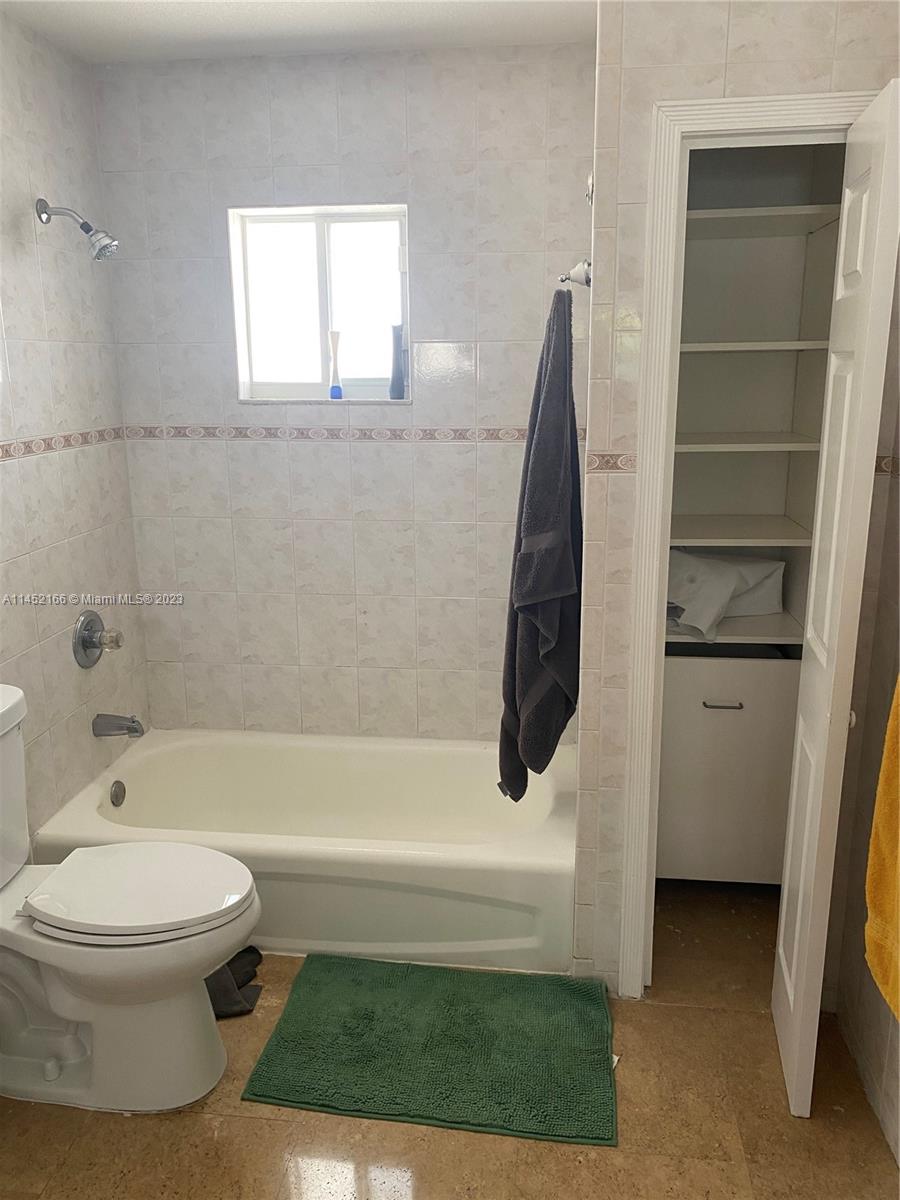 240 Southwest 15th Road, Unit 110 Miami, FL 33129 - Photo 12 of 17 a bathroom with a toilet and a bathtub