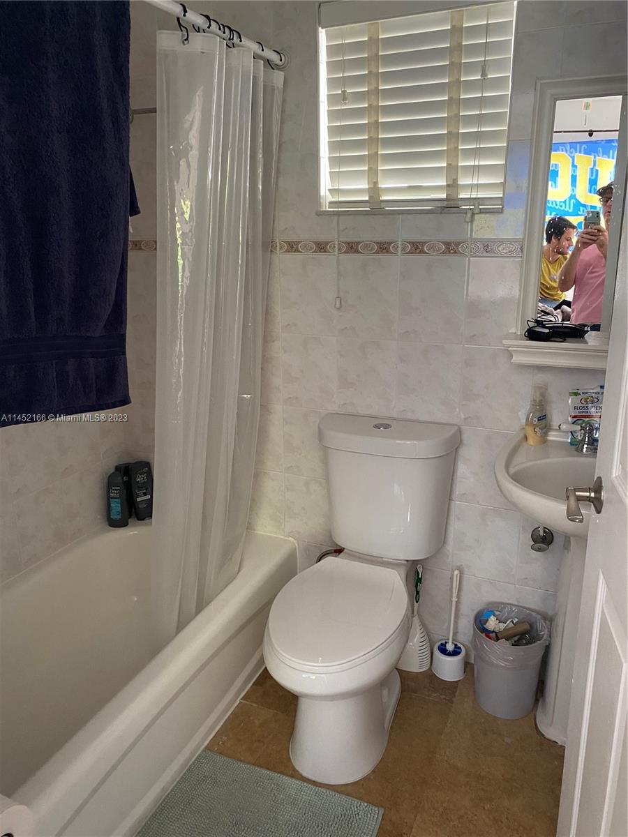 240 Southwest 15th Road, Unit 110 Miami, FL 33129 - Photo 13 of 17 a white toilet sitting next to a bathroom sink