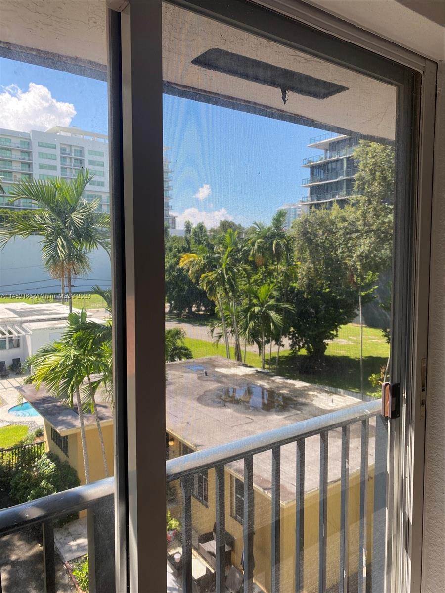 240 Southwest 15th Road, Unit 110 Miami, FL 33129 - Photo 14 of 17 a view of a balcony with a yard