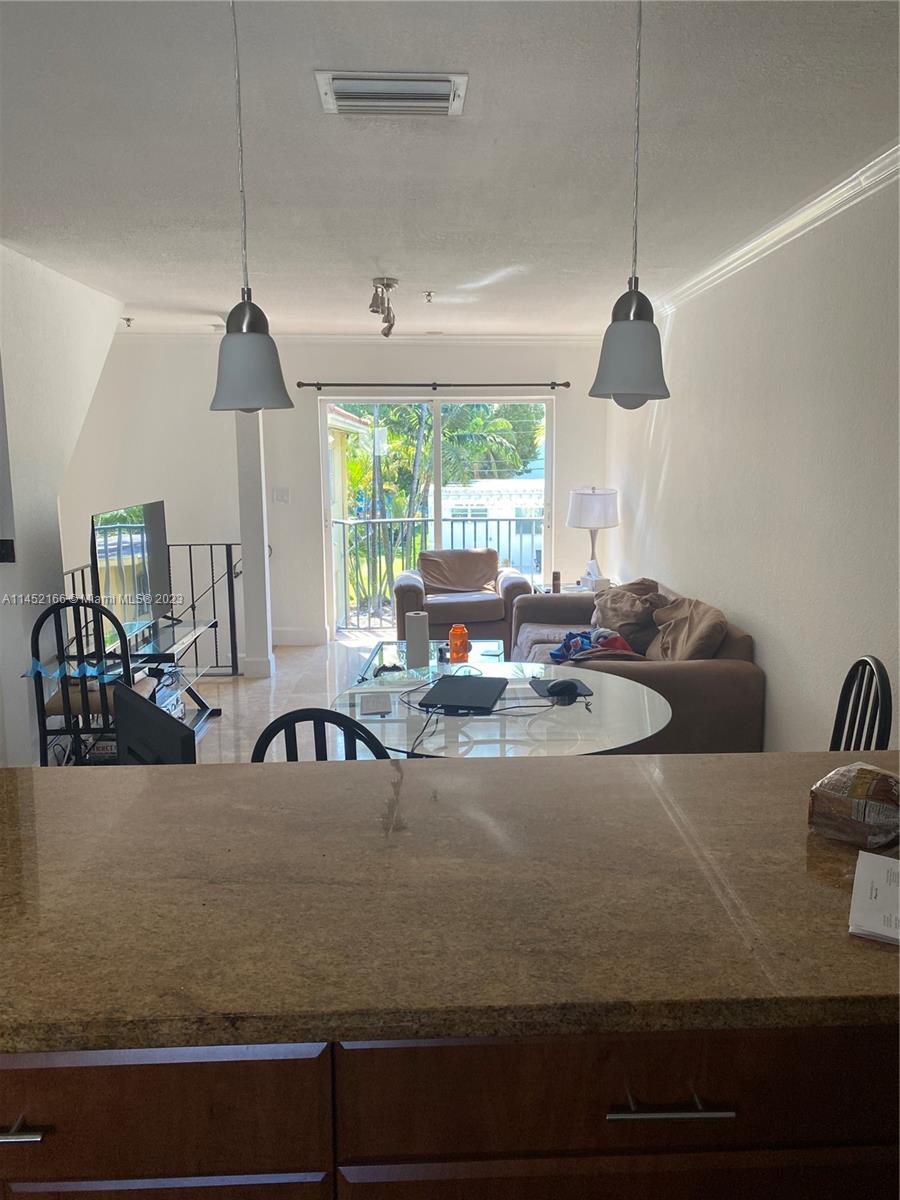 240 Southwest 15th Road, Unit 110 Miami, FL 33129 - Photo 4 of 17 a view of living room with furniture and a chandelier