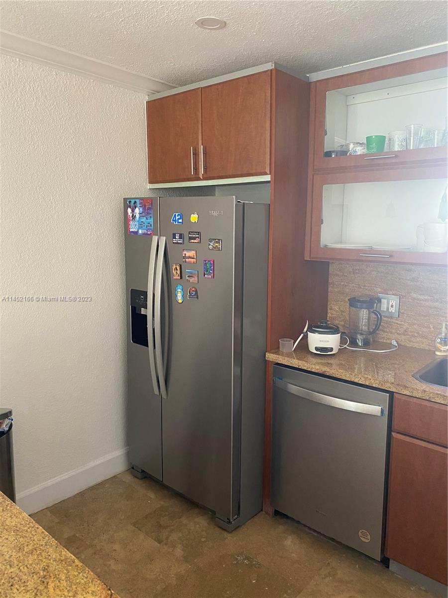 240 Southwest 15th Road, Unit 110 Miami, FL 33129 - Photo 6 of 17 a white refrigerator freezer sitting inside of a kitchen