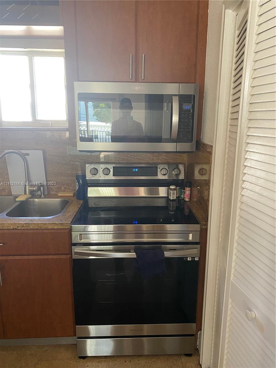 240 Southwest 15th Road, Unit 110 Miami, FL 33129 - Photo 9 of 17 a stove top oven sitting inside of a kitchen