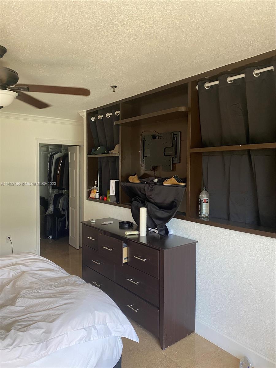 240 Southwest 15th Road, Unit 110 Miami, FL 33129 - Photo 10 of 17 a bedroom with a bed and a mirror