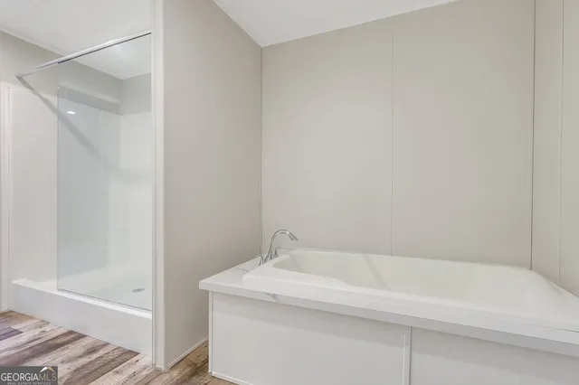 a bathroom with a bathtub and shower