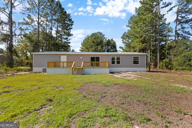 a front view of house with yard and trees