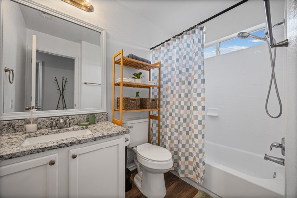 18400 Belfry Pass Manor, TX 78653 - Photo 19 of 22 a bathroom with a granite countertop sink toilet mirror and shower