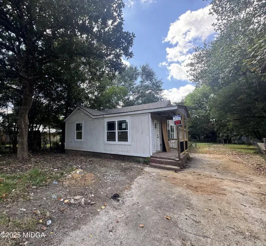 a house with trees in the background