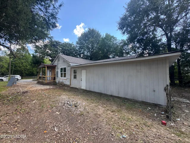 a house with trees in the background