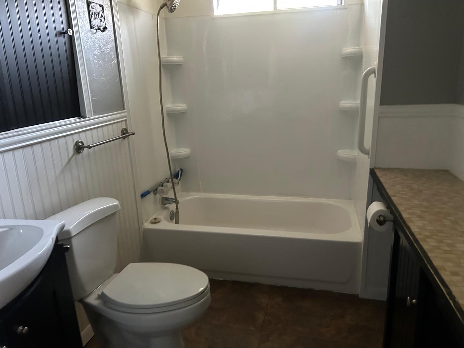 401 Billington Street Clute, TX 77531 - Photo 14 of 22 a bathroom with a granite countertop toilet a sink and bathtub