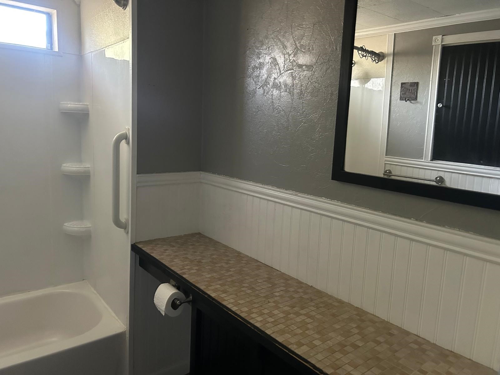 401 Billington Street Clute, TX 77531 - Photo 15 of 22 a bathroom with a granite countertop sink and a mirror