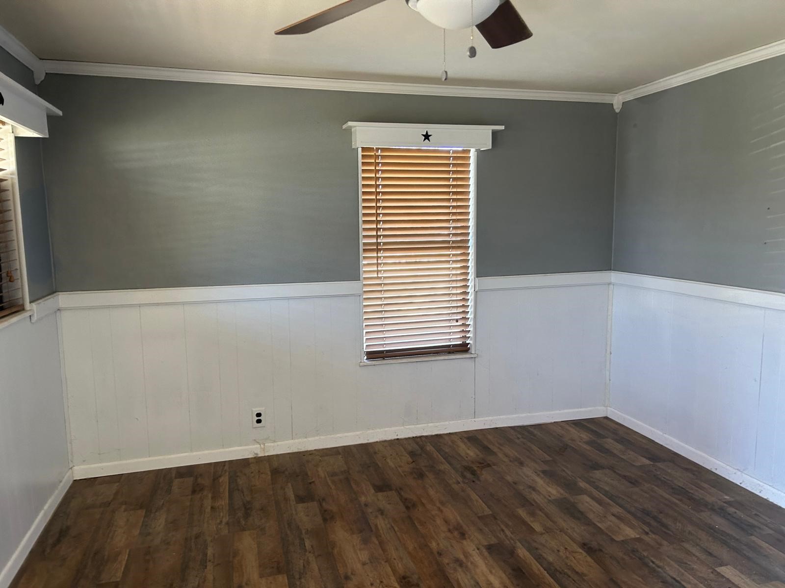 401 Billington Street Clute, TX 77531 - Photo 16 of 22 an empty room with wooden floor and windows