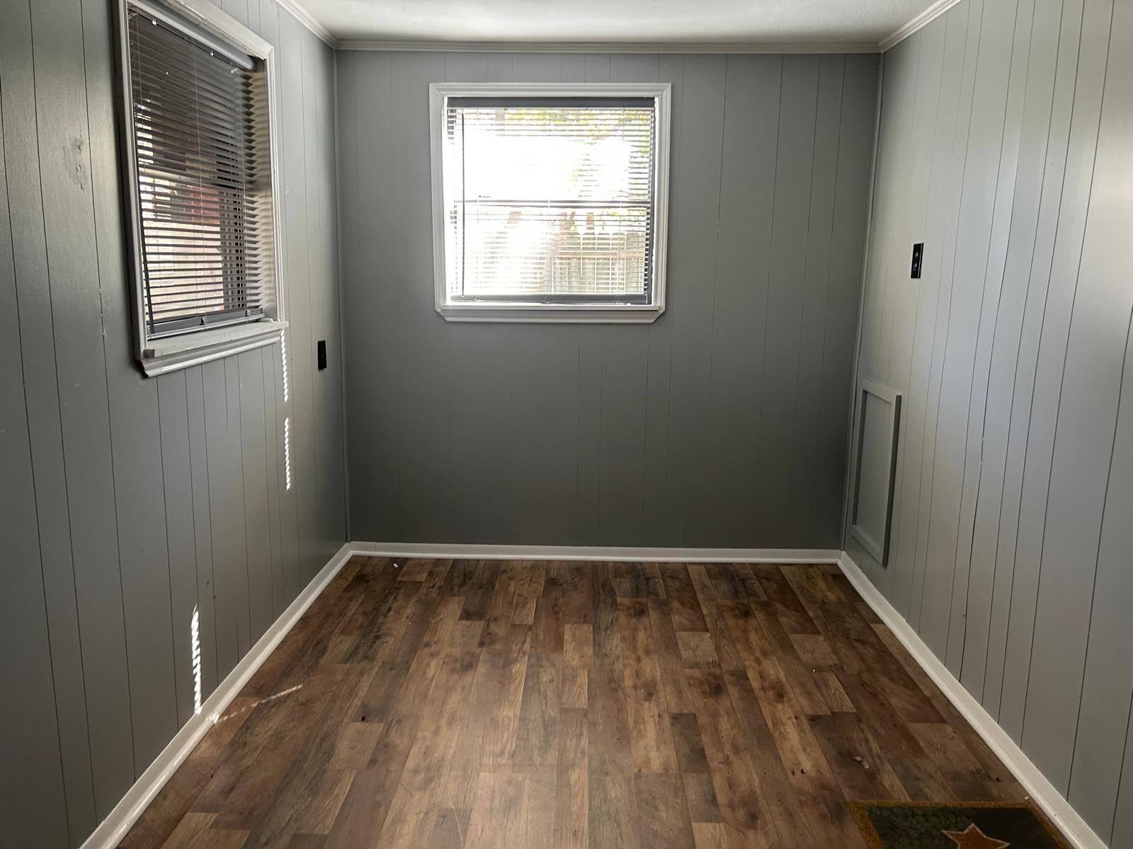 401 Billington Street Clute, TX 77531 - Photo 18 of 22 an empty room with wooden floor and windows
