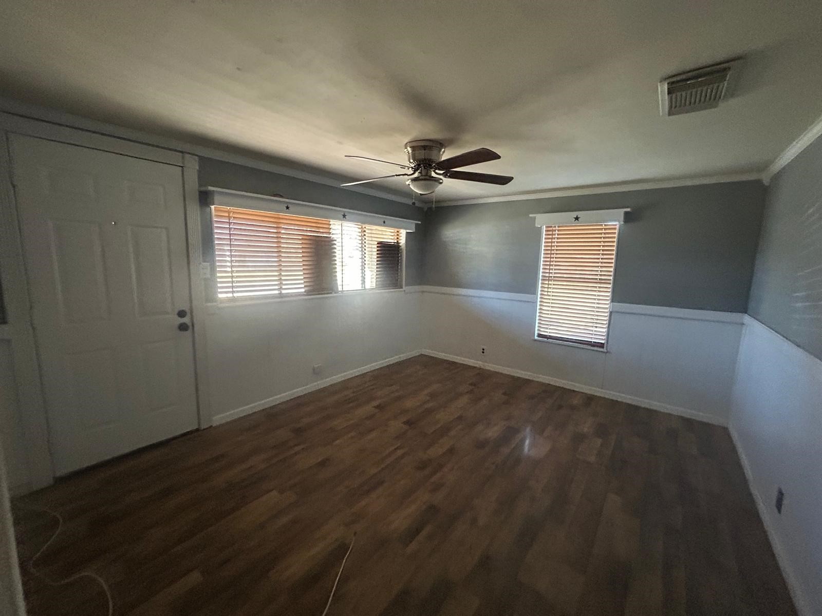 401 Billington Street Clute, TX 77531 - Photo 3 of 22 a view of empty room with wooden floor and fan