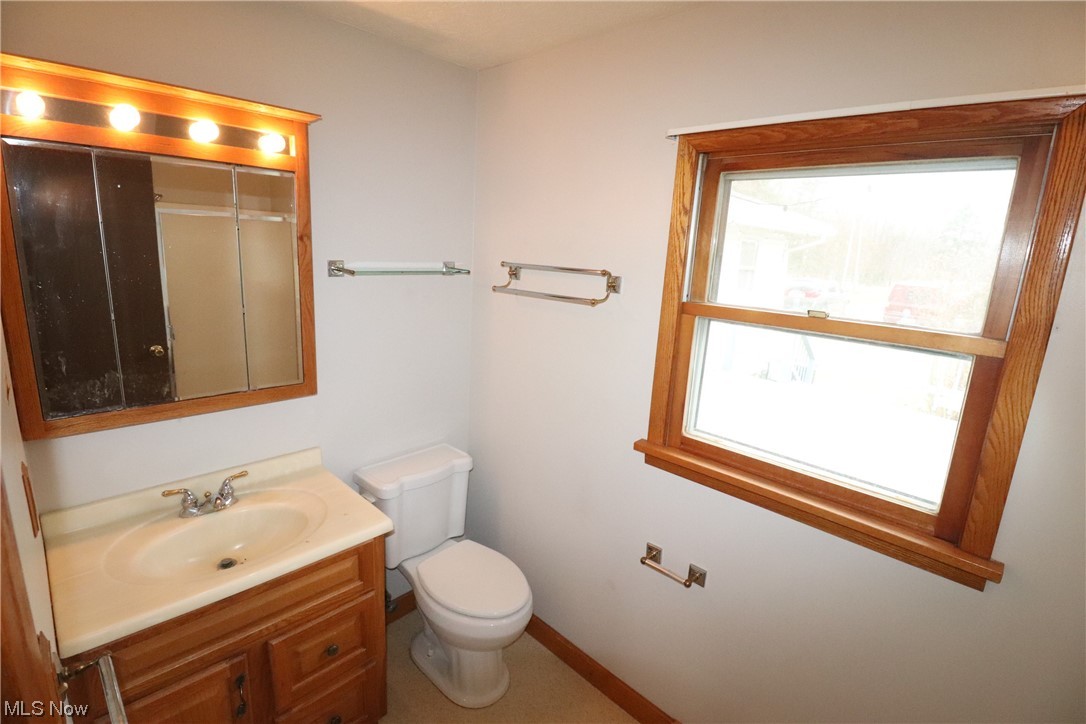 7879 Beach Road Wadsworth, OH 44281 - Photo 7 of 27 Bathroom featuring a wealth of natural light, vanity, and toilet