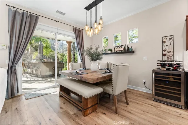 a living room with table chairs and a large window