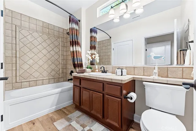 a bathroom with a sink a toilet and bathtub