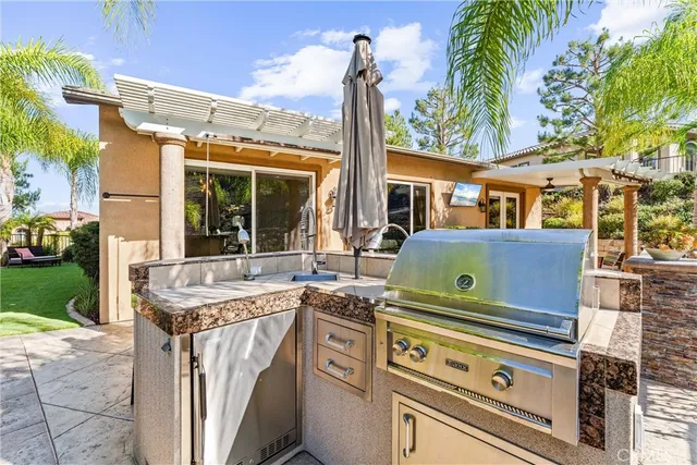 a view of a chair and table in backyard of the house