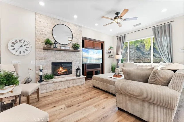 a living room with furniture a fireplace and a large window