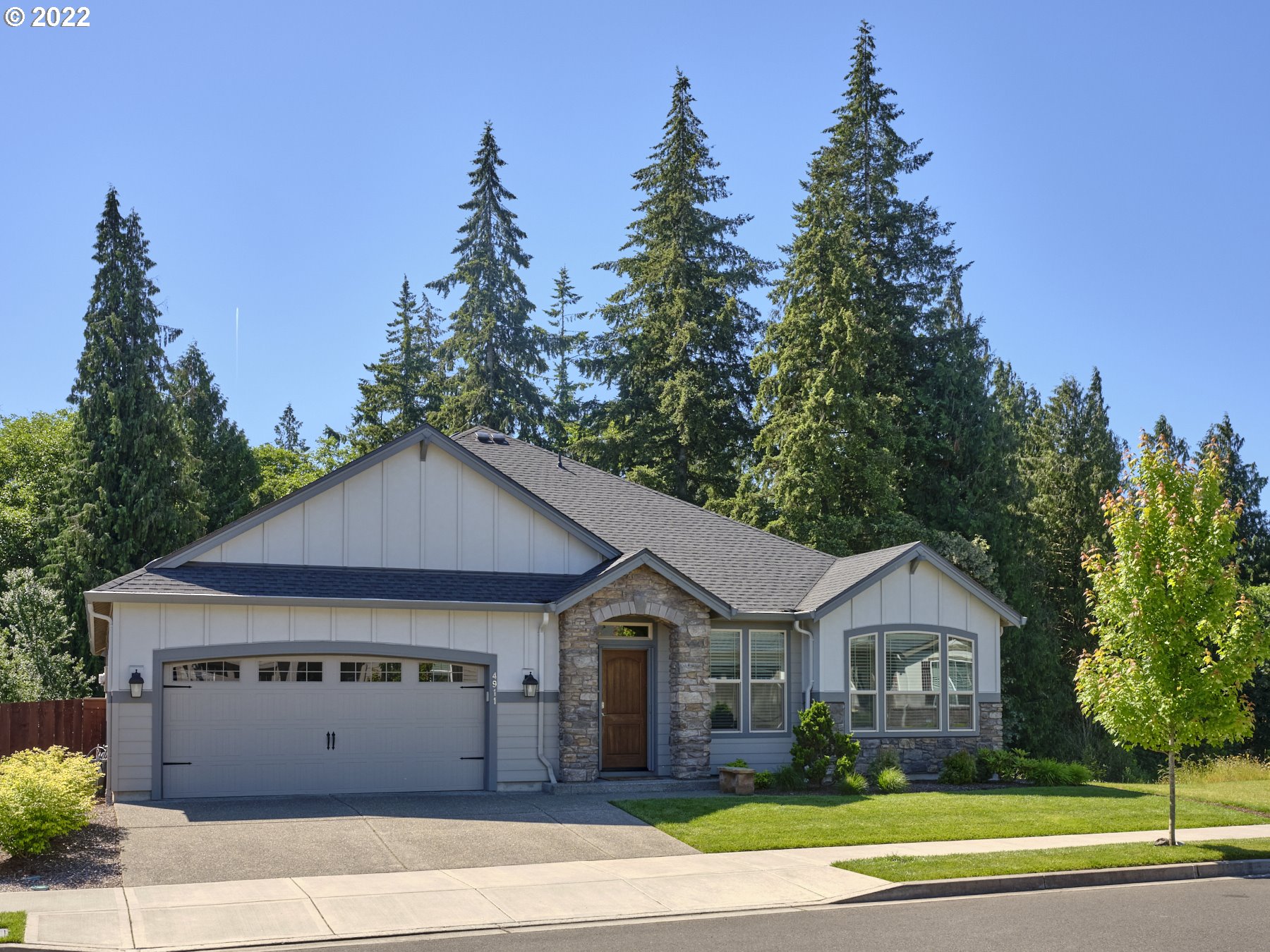 4911 South 19th Street Ridgefield, WA 98642 - Photo 1 of 26 a front view of a house with a garden