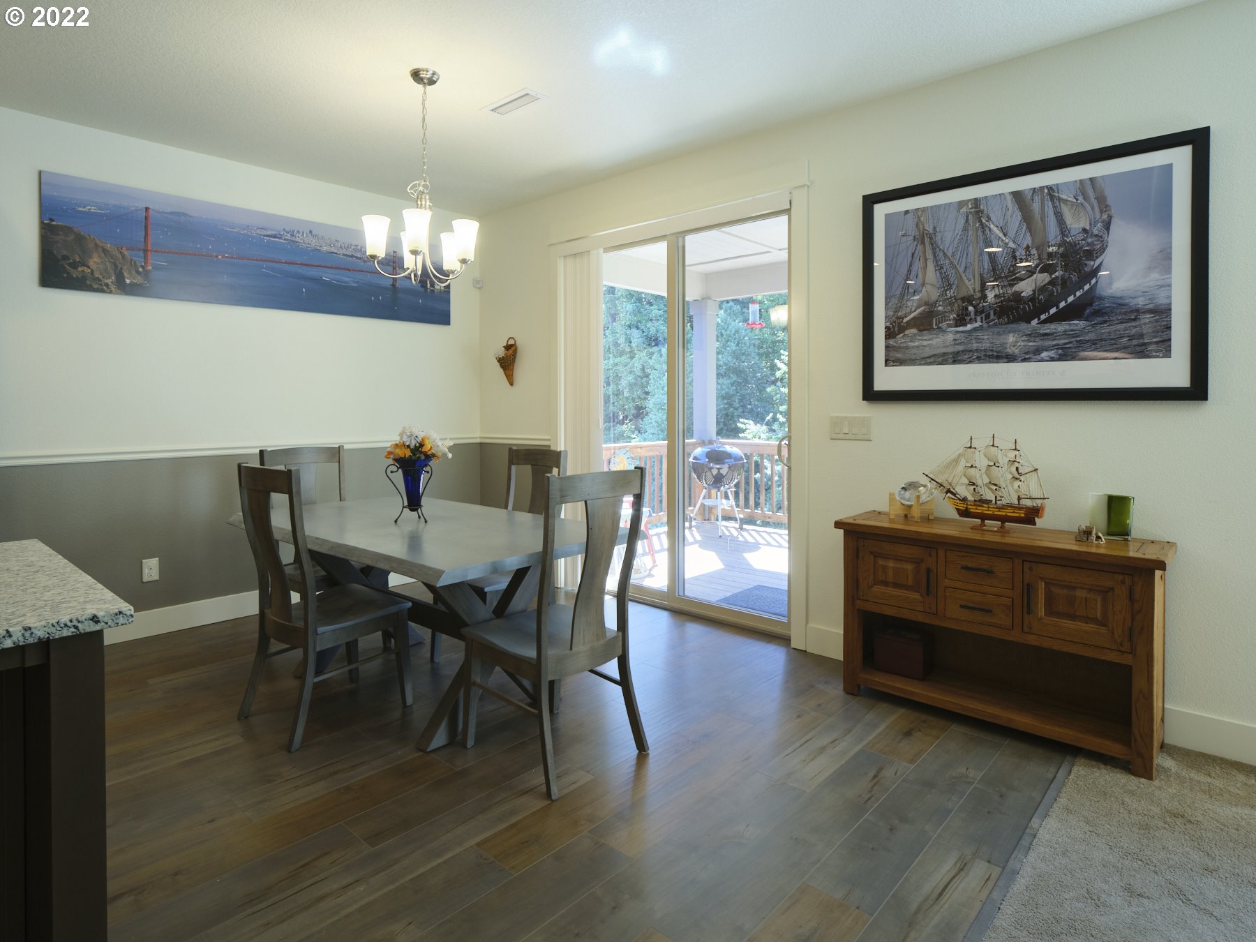 4911 South 19th Street Ridgefield, WA 98642 - Photo 13 of 26 a view of a dining room with furniture a chandelier and wooden floor