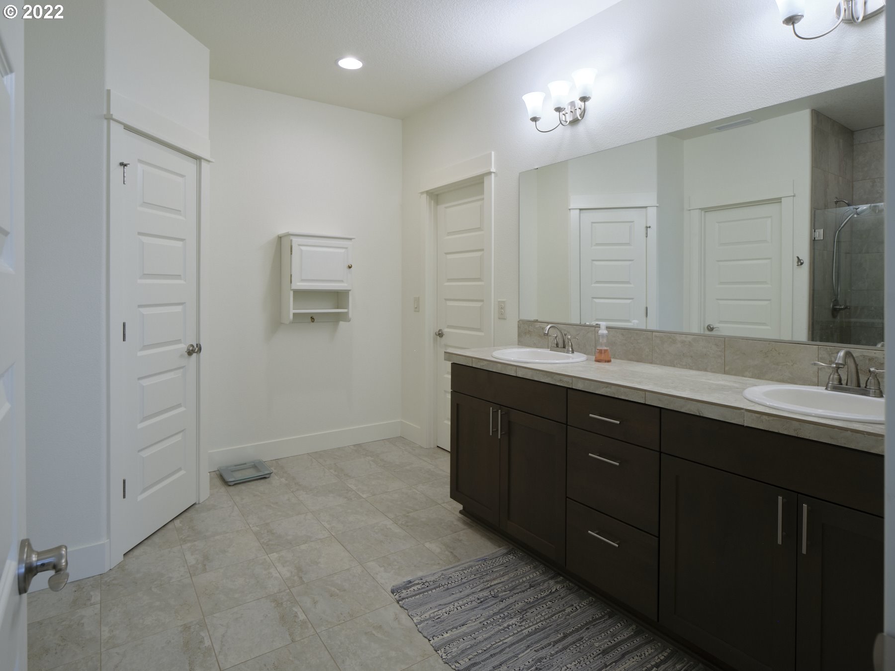 4911 South 19th Street Ridgefield, WA 98642 - Photo 20 of 26 a bathroom with a double vanity sink and mirror
