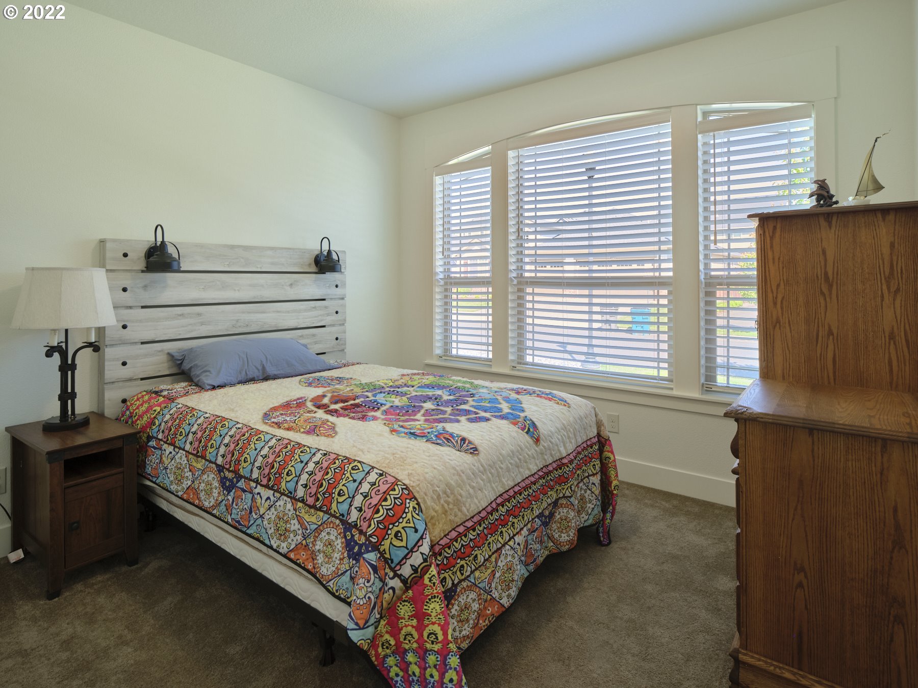 4911 South 19th Street Ridgefield, WA 98642 - Photo 22 of 26 a bed sitting in a bedroom next to a window