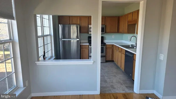 a kitchen with stainless steel appliances granite countertop a refrigerator and a sink