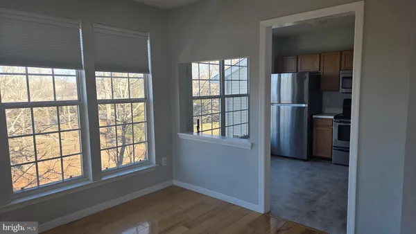 an empty room with windows and closet