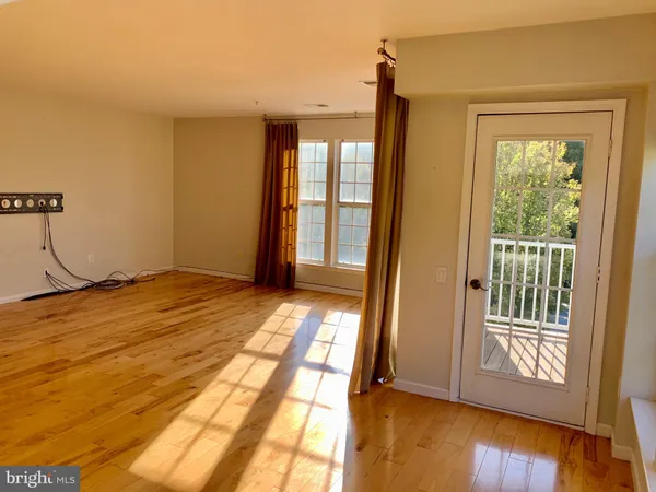 a view of a room with wooden floor and windows