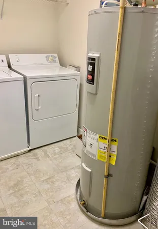 a view of a storage & utility room with a washer dryer