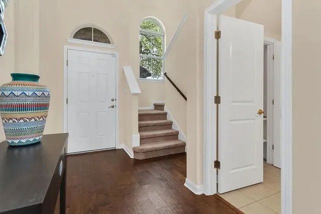 a view of a hallway with entryway wooden floor and front door