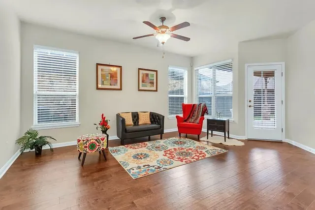 a living room with furniture and wooden floor