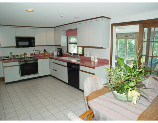 14 Middle Road Amesbury, MA 01913 - Photo 4 of 10 a kitchen with stainless steel appliances granite countertop a sink a stove top oven a counter space and cabinets