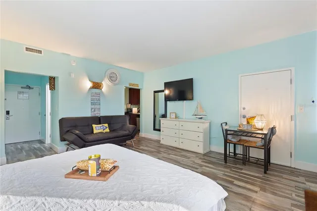 a bedroom with a bed and large windows