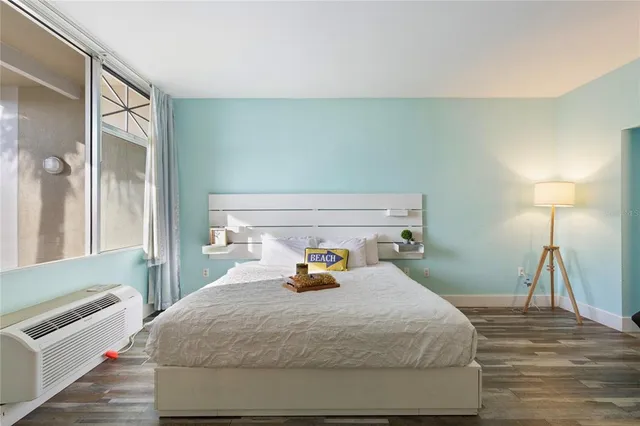 a bedroom with a bed and window