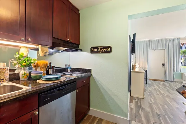 a kitchen with a refrigerator and a sink
