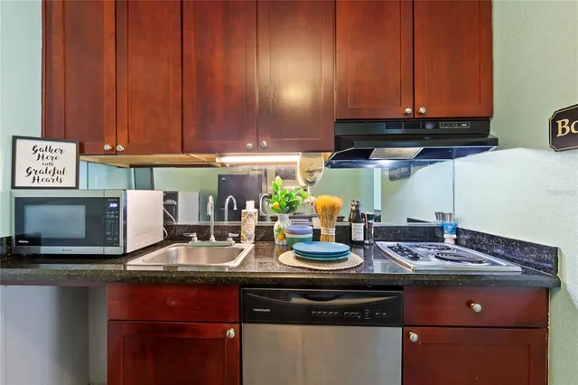 a kitchen with a sink cabinets and appliances