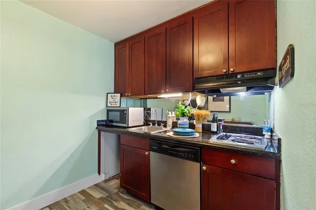 a kitchen with a sink cabinets and appliances