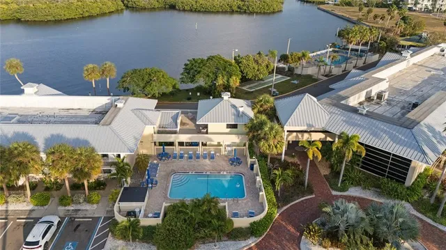 a view of a house with a yard and a potted plant