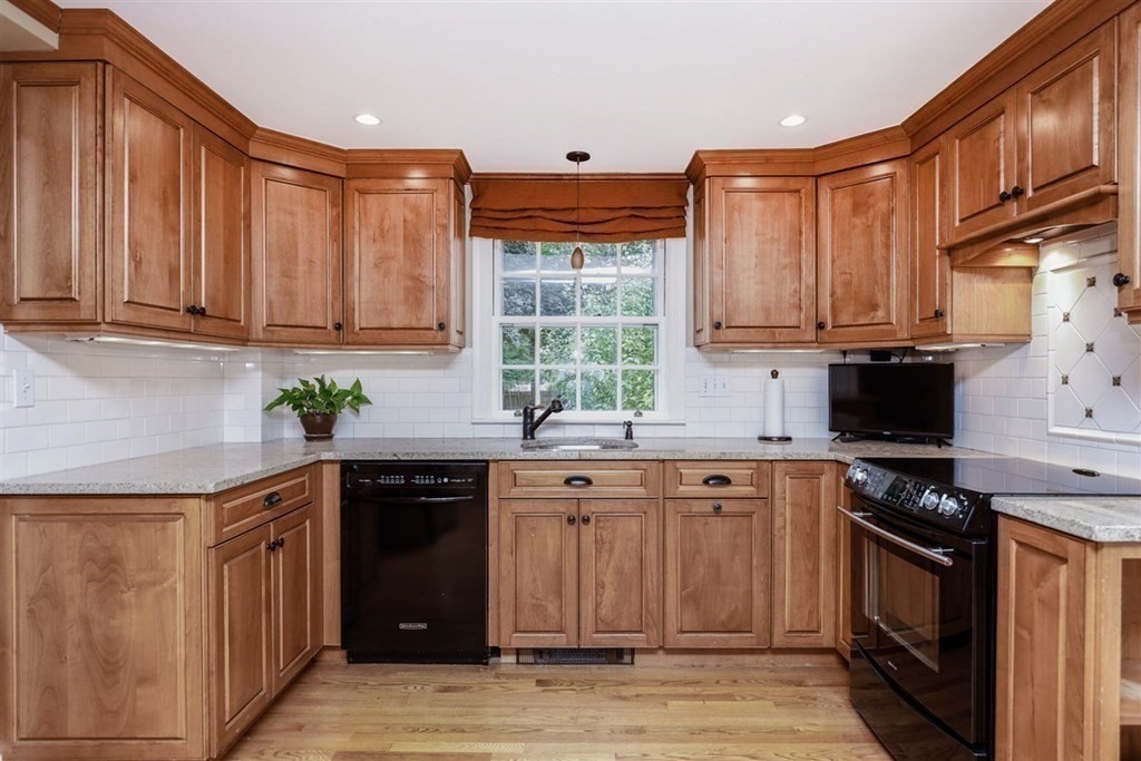 20 Chesterton Road Wellesley, MA 02481 - Photo 8 of 31 a kitchen with stainless steel appliances granite countertop a stove a sink dishwasher and cabinets with wooden floor