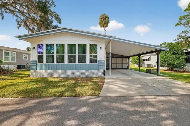 a view of a house with a swimming pool and porch