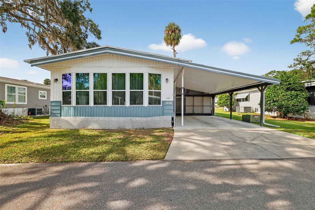 a view of a house with a swimming pool and porch