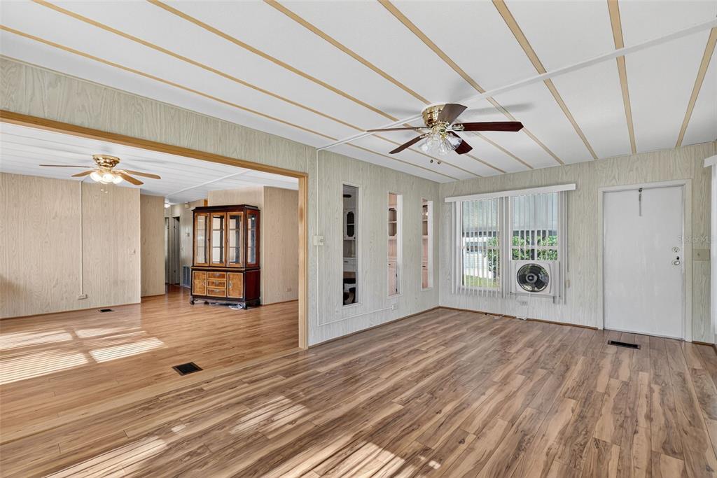 165 Shady Lane Eustis, FL 32726 - Photo 12 of 25 a view of a livingroom with wooden floor and a ceiling fan