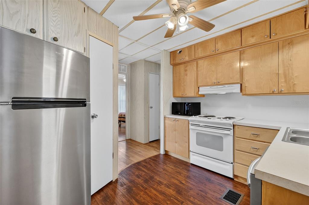 165 Shady Lane Eustis, FL 32726 - Photo 13 of 25 a kitchen with a refrigerator and a stove top oven