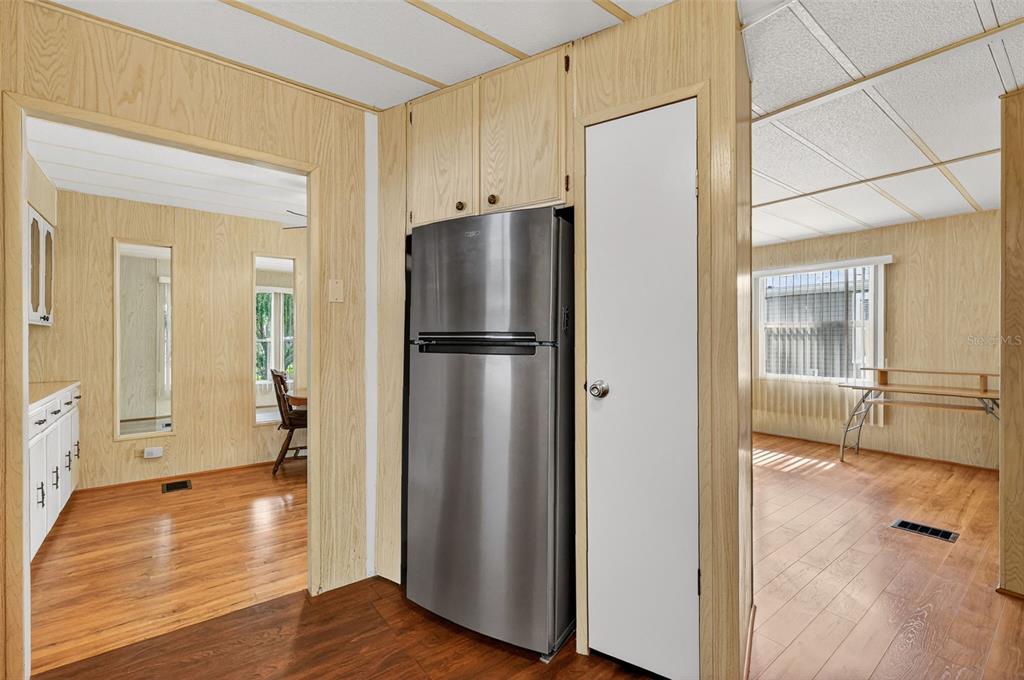 165 Shady Lane Eustis, FL 32726 - Photo 16 of 25 a view of a refrigerator in kitchen and wooden floor